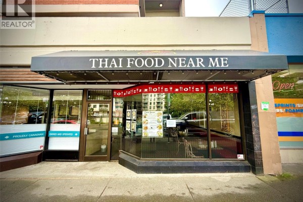Street view of a commercial storefront with a black awning that says "Thai Food Near Me". - 915 Fort St, Victoria