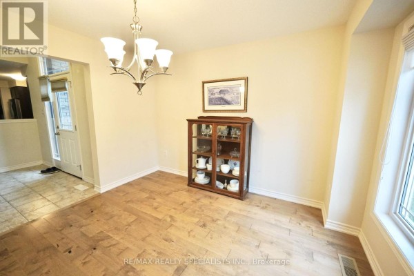 Dining room with wood floors, a china cabinet, and a doorway to another room. - 92 Aberdeen Street, Centre Wellington