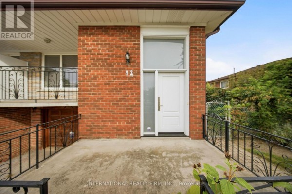 Close-up of the front entrance with a white door and brick facade. - 92 Andrew Park, Vaughan