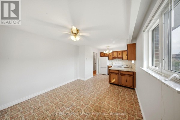 Combined kitchen and living space with white walls and a ceiling fan. - 92 Andrew Park, Vaughan