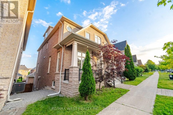 Side view of the house with brick exterior, covered porch, and green landscaping. - 92 Glengordon Crescent, Markham