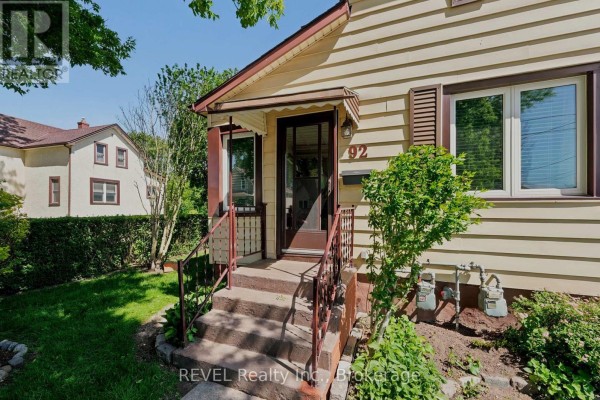 Close-up of the front door area, including the porch, steps, and house number 92. - 92 Saint Arnaud Street, Port Colborne