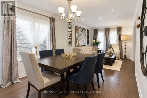 Dining room with a large wood table, upholstered chairs, and a view into the kitchen. - 92 Weldrick Road E, Richmond Hill