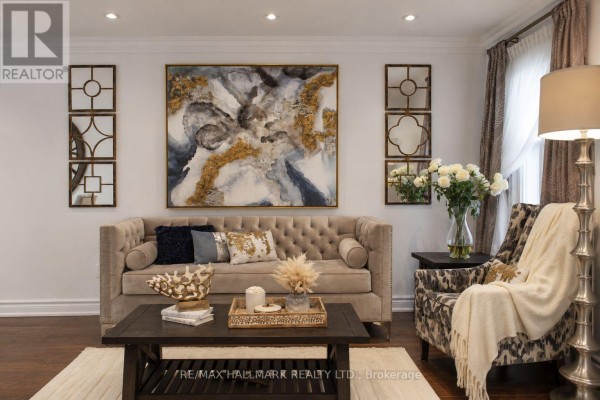 Open-concept dining and living area with hardwood floors, large windows, and elegant furnishings. - 92 Weldrick Road E, Richmond Hill