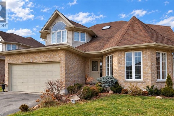 Close-up of the brick exterior of a house with a garage and large windows. - 920 Marl Meadow Court, Kitchener