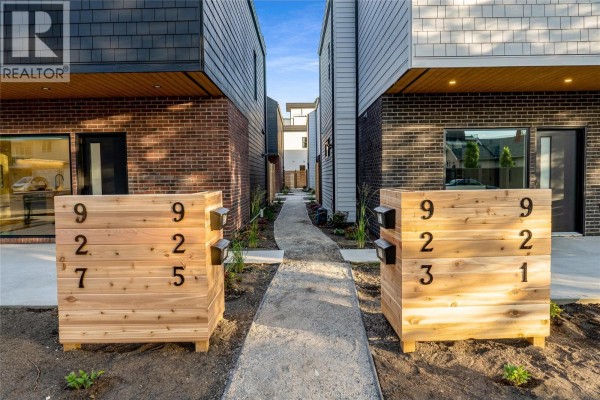 Wooden address planters with numbers 927, 925, 923, and 921 on a gravel path. - 921 Borden Avenue, Kelowna