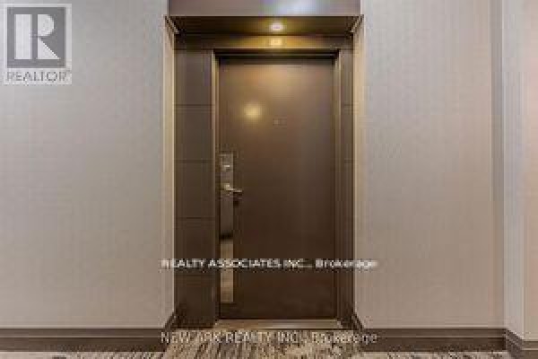 A closed, dark brown apartment door with a silver handle and lock. - 922 - 30 Clegg Road, Markham