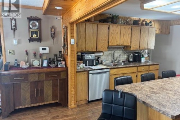 Entryway with a door, storage cabinets, and items on the floor. - 922 & 928 Lakeshore Dr., Turtle Lake