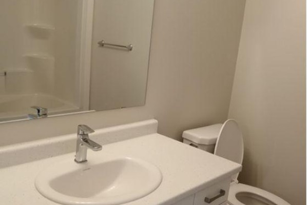 Compact bathroom with white vanity, sink, chrome faucet, and toilet. - 924 Georgetown Drive, London North