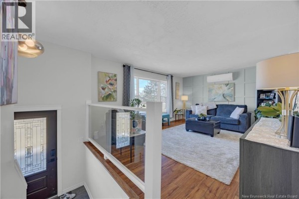 A primary bedroom with a king-size bed, light blue walls, and a patterned rug. - 9250 Route 3, Old Ridge