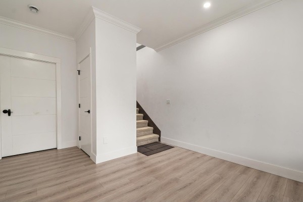 Hallway with stairs leading to the upper level and a door to the left - 9262 Sitka Place, Chilliwack Proper East, Chilliwack