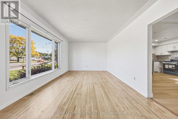 Kitchen with brown cabinetry, white appliances, and tiled flooring - 928 Upper Gage Avenue, Hamilton