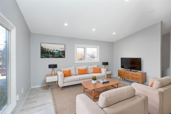 Empty room with light gray walls, a large picture window, and a smaller window. - 93 Vandale Street, Ste Anne