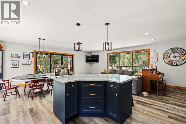 Interior entryway with a black door, wood trim, and blue walls. - 93 Westwood Road, Lumby