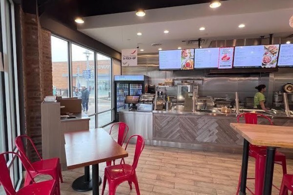 Interior of a restaurant with large windows, dining tables, counter service, and digital menus. - 930 - 13850 Steeles Avenue, Halton Hills