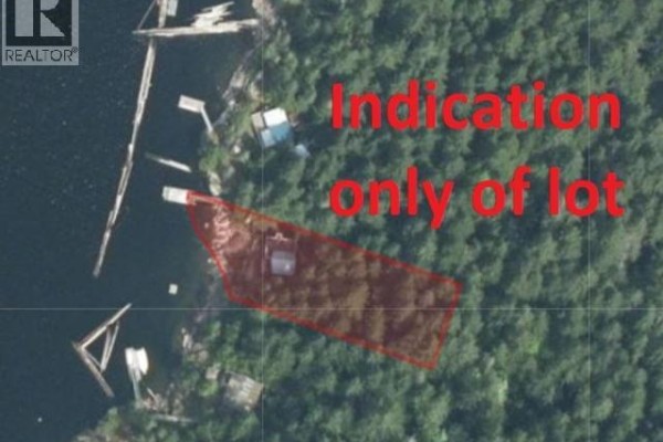 Aerial view of a property lot outlined in red, situated on a wooded shoreline with water access. - 9302 Powell Lake, Powell River