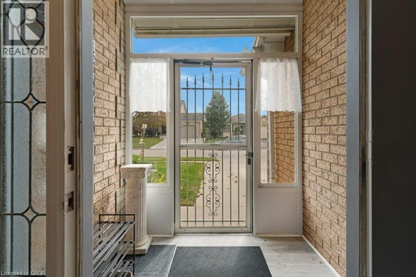 View from inside the screened porch looking out to the front yard. - 94 Dawn Crescent, Cambridge