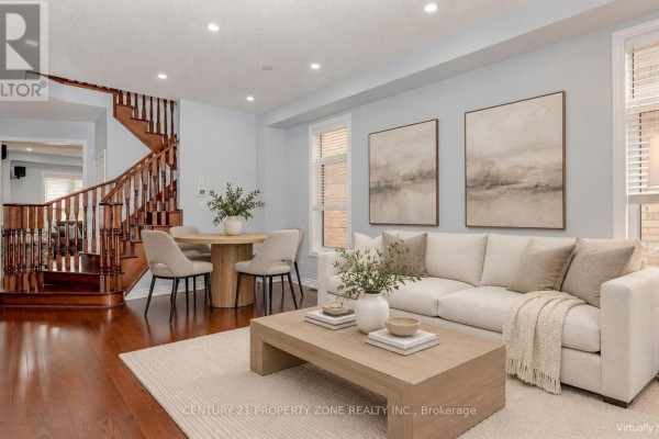 Living room with a beige sectional sofa, a light wood coffee table, and a dining set with wood floors. - 94 Lola Crescent, Brampton