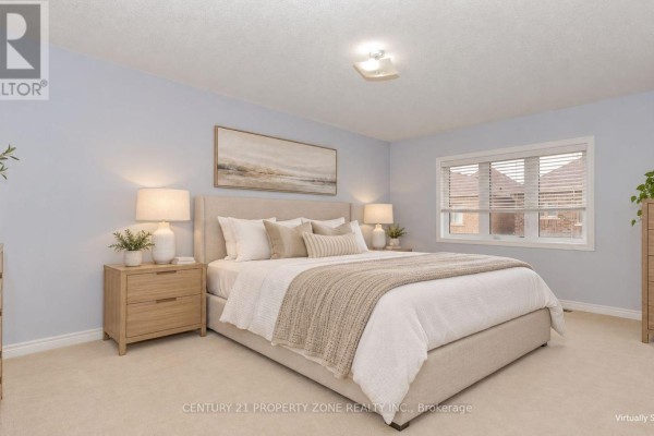 Primary bedroom with a beige upholstered king-size bed, light wood nightstands, and light blue walls. - 94 Lola Crescent, Brampton