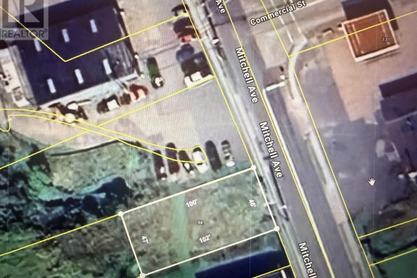 Vacant lot with remnants of snow and sparse vegetation, adjacent to residential buildings. - 94 Mitchell Ave Dominion Land, Dominion