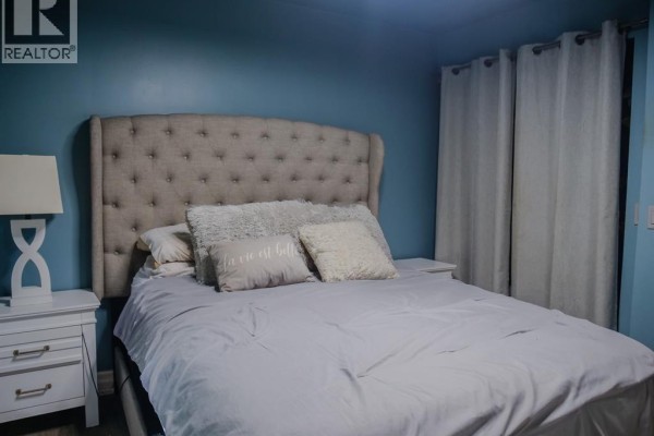 Bedroom with tufted headboard and nightstand - 94 Ottawa Drive Chatham