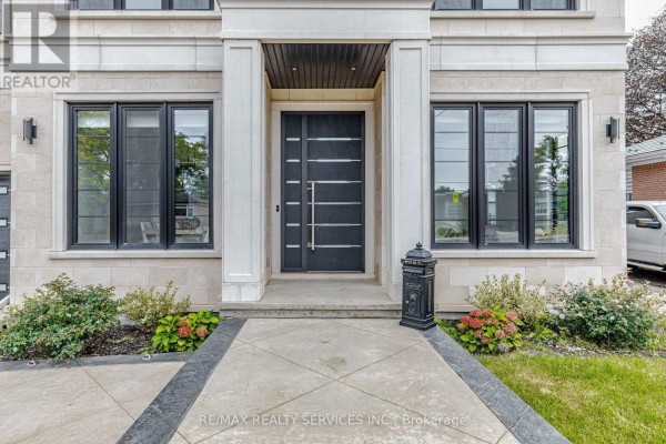 Close-up of the modern black front door with horizontal panels and flanking windows. - 94 Vista Boulevard, Mississauga