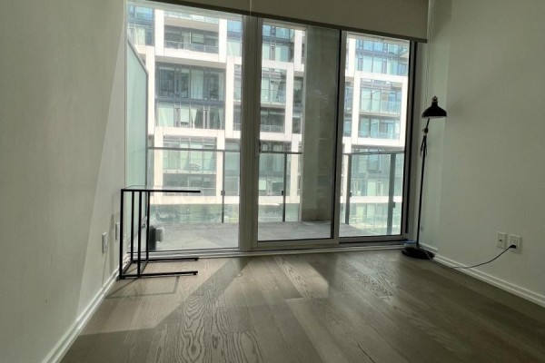 Room with large sliding glass doors to balcony and dark wood flooring. - 943 - 8 Hillsdale Avenue E, Toronto