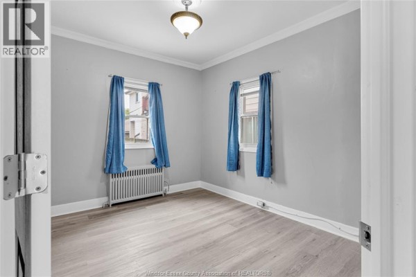Kitchen with white quartz countertops, white cabinets, and black hardware. - 946 Howard Avenue Unit# 1&2, Windsor
