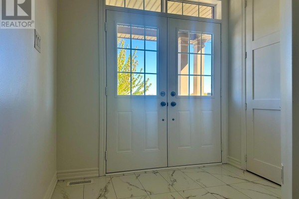 Unfinished basement with wood plank flooring, drywall, and a view of the stairs. - 949 Line 9 Road, Niagara On The Lake