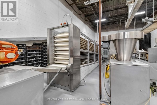 Close-up of industrial food processing machine with conveyor belts and control panel. - 95 Bessemer Road, London South