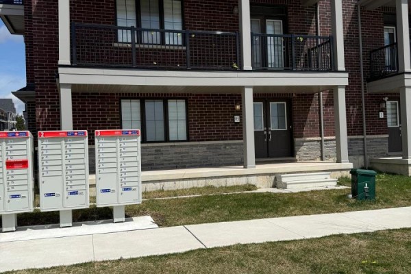 Mailboxes numbered 1-3 outside a brick apartment building. - 95 Norwich Crescent, Haldimand