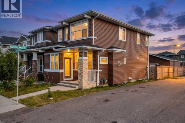 View of the house from the driveway, showing the front entrance and side of the home. - 95 Redstone Park Ne, Calgary