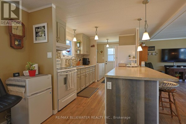 Kitchen with island, pendant lights, and appliances - 95 Shannon Boulevard South Huron