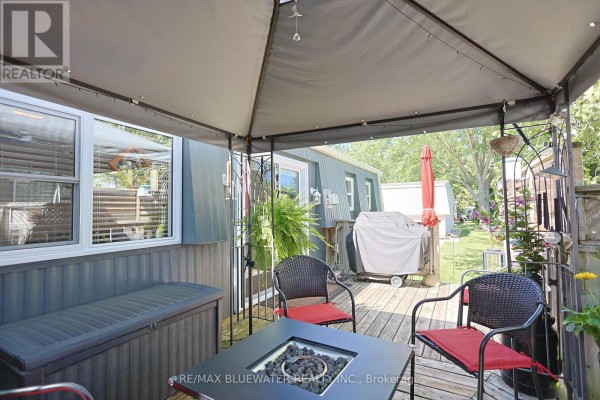 Covered patio with fire pit, grill, and seating - 95 Shannon Boulevard South Huron