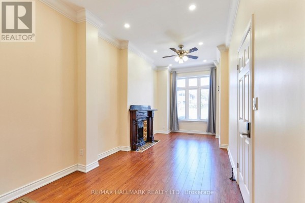 Kitchen with natural wood cabinets, beige tile backsplash, and white appliances. - 95 Wolseley Street, Toronto