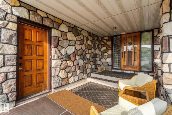 Overhead view of a bungalow roof with a skylight, surrounded by green lawn and fencing. - 9504 139 Av Nw, Edmonton