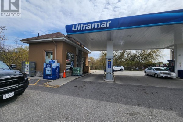 Side view of Ultramar gas station pumps and convenience store building. - 951 Dundas Street W, Whitby