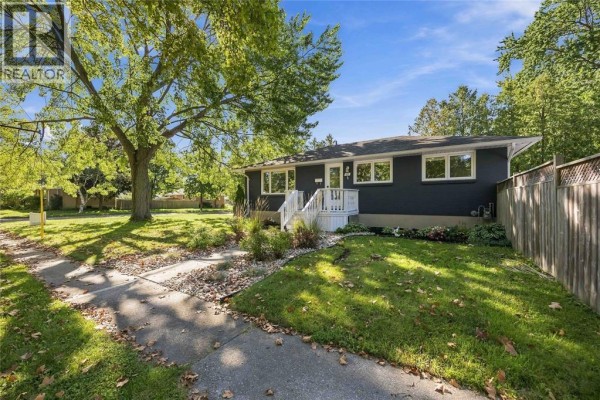 A grey bungalow with white stairs and a walkway leading to the front door. - 957 Kensington Boulevard, Sarnia