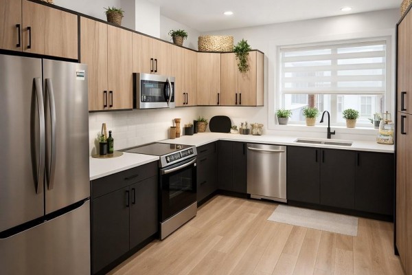 Interior view of a townhouse showing a staircase, wooden cabinetry, and a dining area. - 957 Snapdragon Crt, Langford