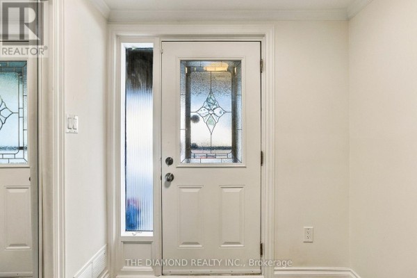 Interior view of a white front door with stained glass panels and a sidelight window. - 41 Carl Shepway, Toronto