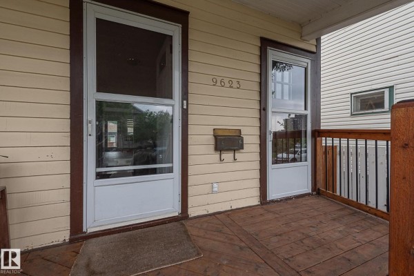 Double front doors with screen doors, address number 9623, and a mailbox. - 9623 110a Av Nw, Edmonton