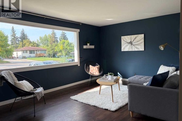 Kitchen view with a stainless steel refrigerator and a tall wooden hutch. - 9626 108 Avenue, Grande Prairie