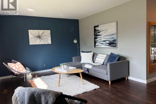 Kitchen and dining area with a refrigerator, hutch, and a light fixture. - 9626 108 Avenue, Grande Prairie