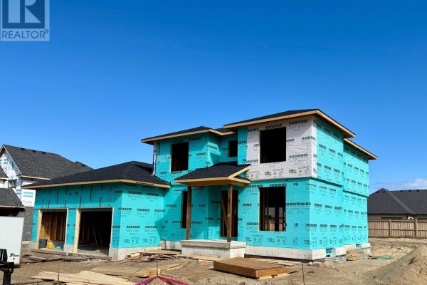Under-construction house with blue house wrap, black roof, and unfinished garage.  - 968 Bogdanovic Way, Huron Kinloss