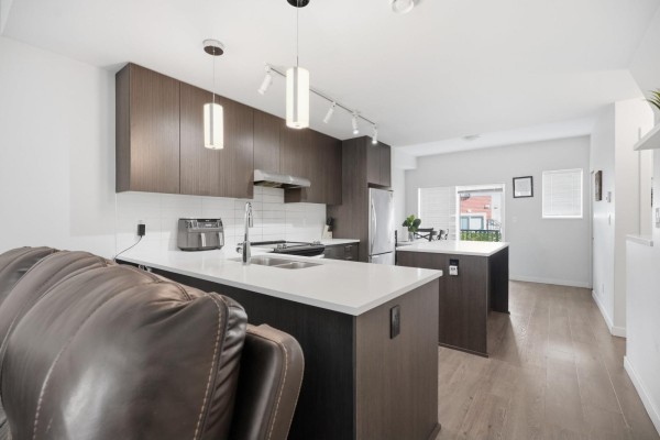 Kitchen with dark cabinetry, white countertops, and pendant lighting - 97 32633 Simon Avenue, Abbotsford