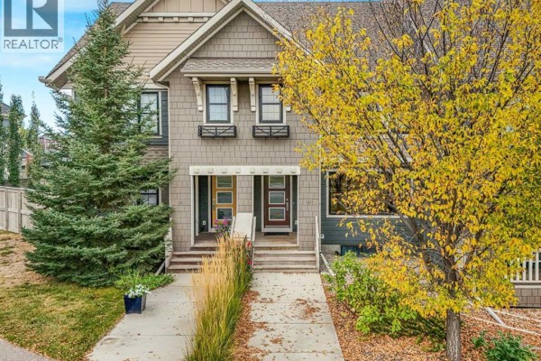 Front exterior of two attached townhouses with modern doors and landscaping. - 97 Marine Drive Se, Calgary