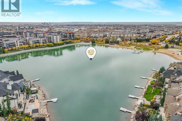 Aerial view of a lakefront community with townhouses and apartment buildings. - 97 Marine Drive Se, Calgary