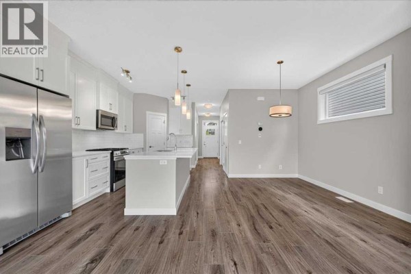 Open concept living space with a modern kitchen and dining area. - 97 Seton Manor Se, Calgary