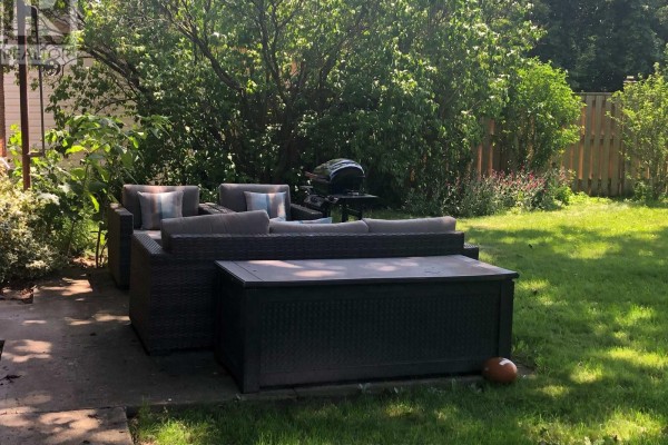 Outdoor patio furniture set with sofa, chairs, and storage chest on concrete. - 97 Shakespeare Avenue, St  Catharines