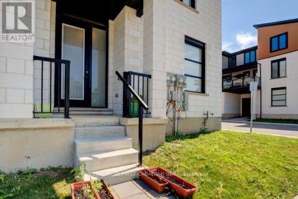 Close-up of townhouse entrance stairs and exterior utility boxes. - 970 Battery Park, London North